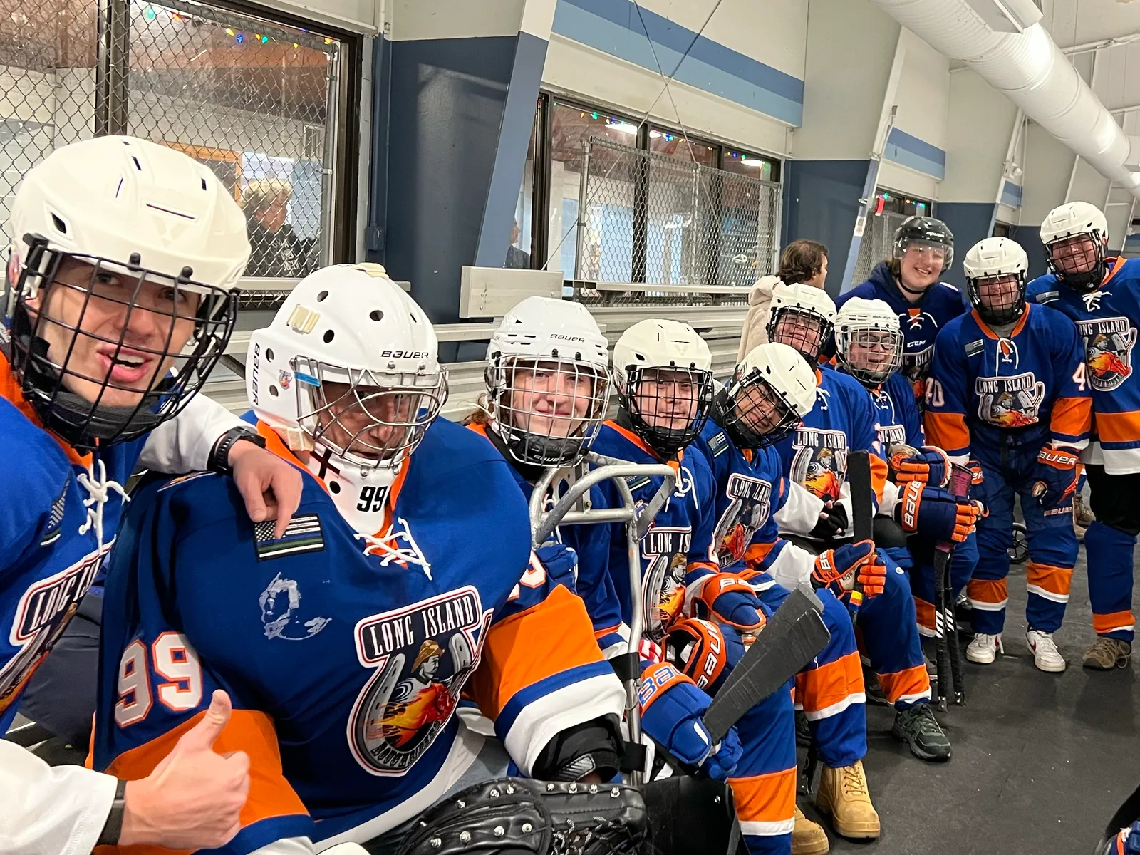 The Long Island Sled Hockey RoughRiders together at the rink
